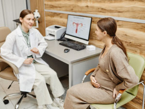 woman consulting obstetrician to ensure healthy pregnancy