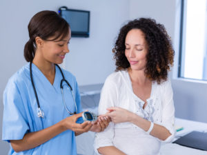 doctor providing preventive healthcare for a pregnant woman