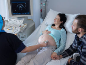 Doctor doing ultrasound test on a high-risk pregnancy