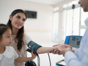 doctor checking blood pressure as part of preventive care