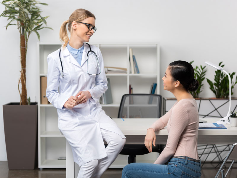 woman consulting with doctor to illustrate preventive healthcare