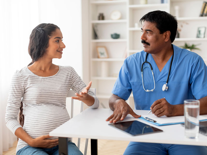 pregnant woman consulting with a women's healthcare specialist