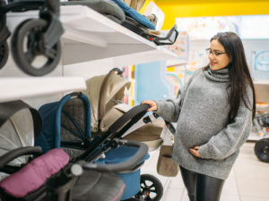 pregnant woman shopping in second trimester for baby goods