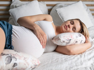 Pregnant woman resting to illustrate self-care during second trimester of pregnancy