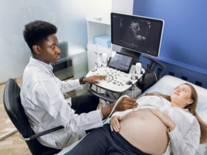 Woman getting ultrasound to illustrate milestones in pregnancy