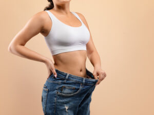 Woman demonstrating weight loss to illustrate hormone pellet therapy