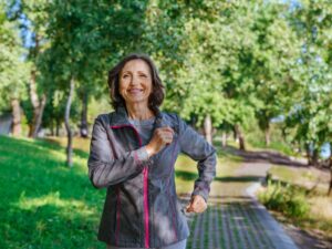 happy mature woman jogging, to illustrate successful hormone pellet therapy