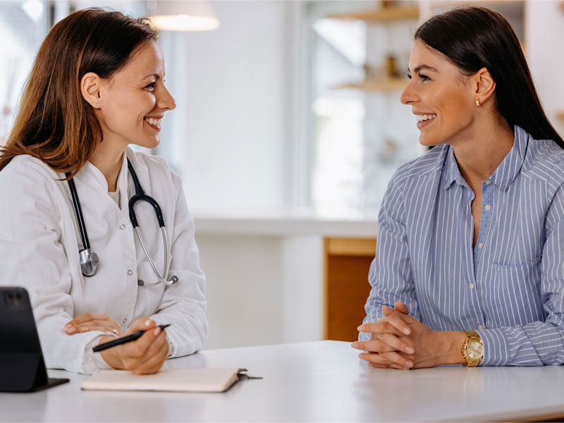 Woman and doctor talking, to illustrate hormone pellet therapy discussion