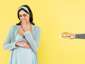 pregnant woman showing aversion to food as a symptom of first trimester of prgnancy