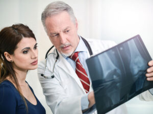 doctor talking to patient to illustrate postmenopausal osteoporosis