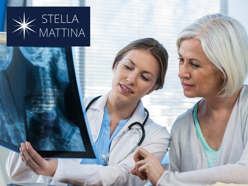 older woman and doctor looking at an x-ray of a spine to illustrate hormone therapy for osteoporosis