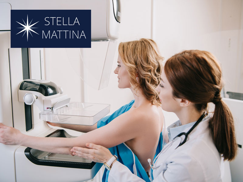 nurse helping a woman have mammogram screening to illustrate breast cancer awareness