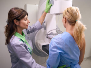 radiologist and female patient to illustrate type of mammogram: 2D or 3D