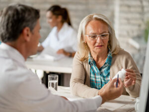 senior woman consults with doctor to illustrate treating diabetes and menopause