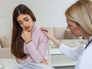 Doctor comforting young female to illustrate testing positive for STDs during pregnancy