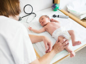Newborn receives checkup to illustrate importance of HIV testing pre and postpartum