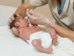 Nurse taking slaiva sample from baby to illustrate testing babies for HIV