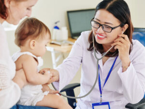 doctor listening to young girl's chest to illustrate benefit of breastfeeding after one or two years