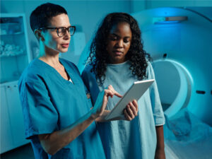 doctor using a tablet to show test results to a female patient