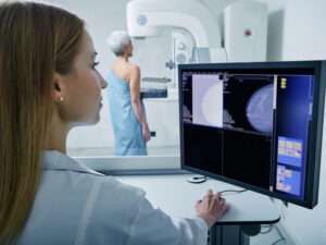 technician looking at mammogram screening results