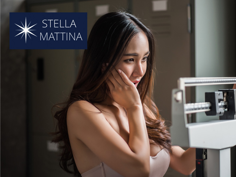 woman looking shocked with exercise equipment read-out to illustrate can hormones cause weight gain