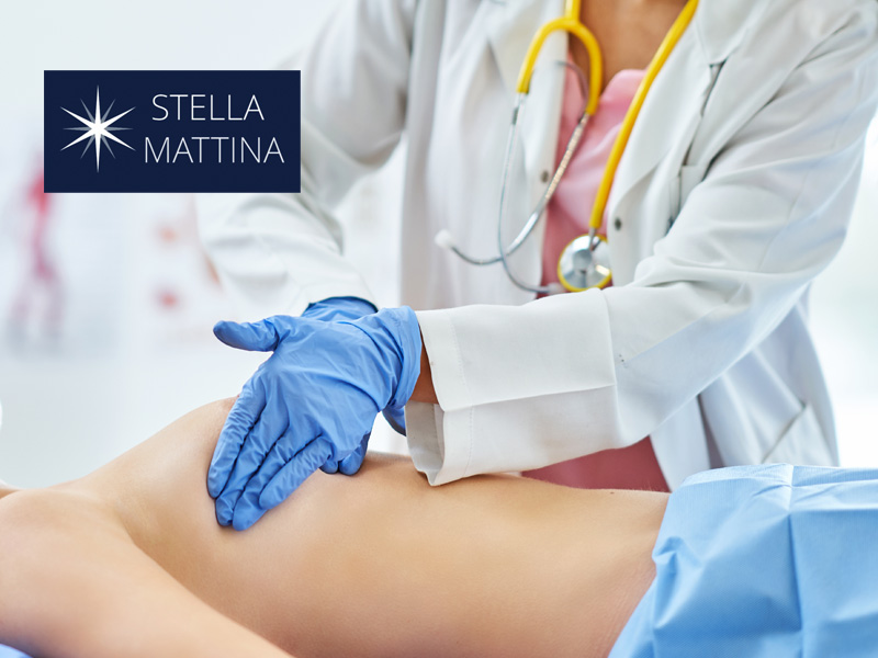 doctor examining a patient's breast to illustrate breast cancer check-up