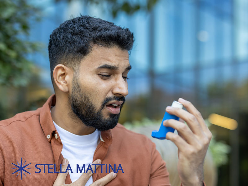 young man with an inhaler for an asthma attack to illustrate acute and chronic conditions
