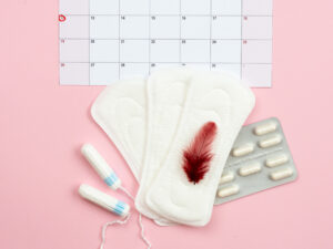 tampons, pad, calendar and pills to illustrate irregular period after birth
